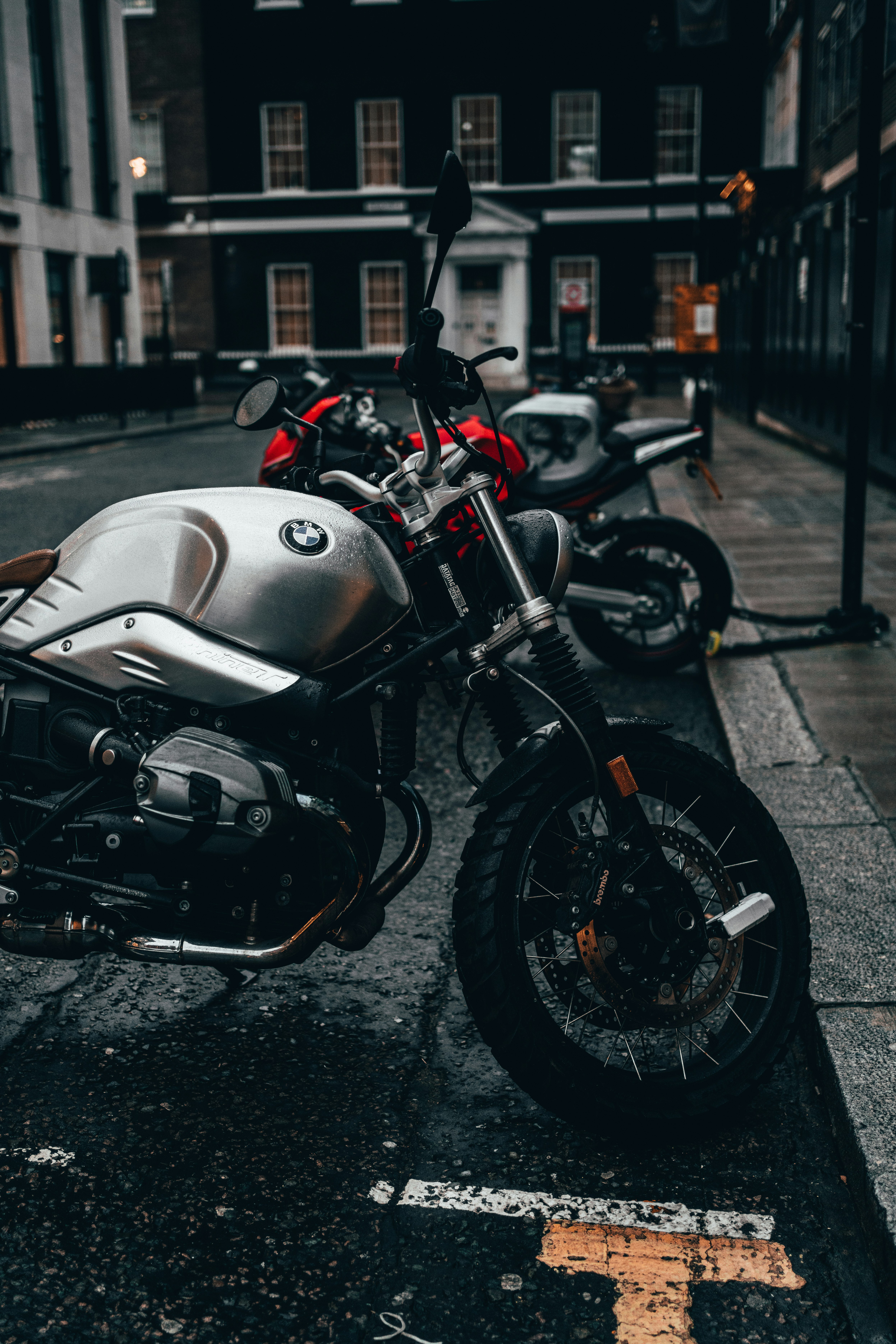 white and black sports bike parked on sidewalk during daytime